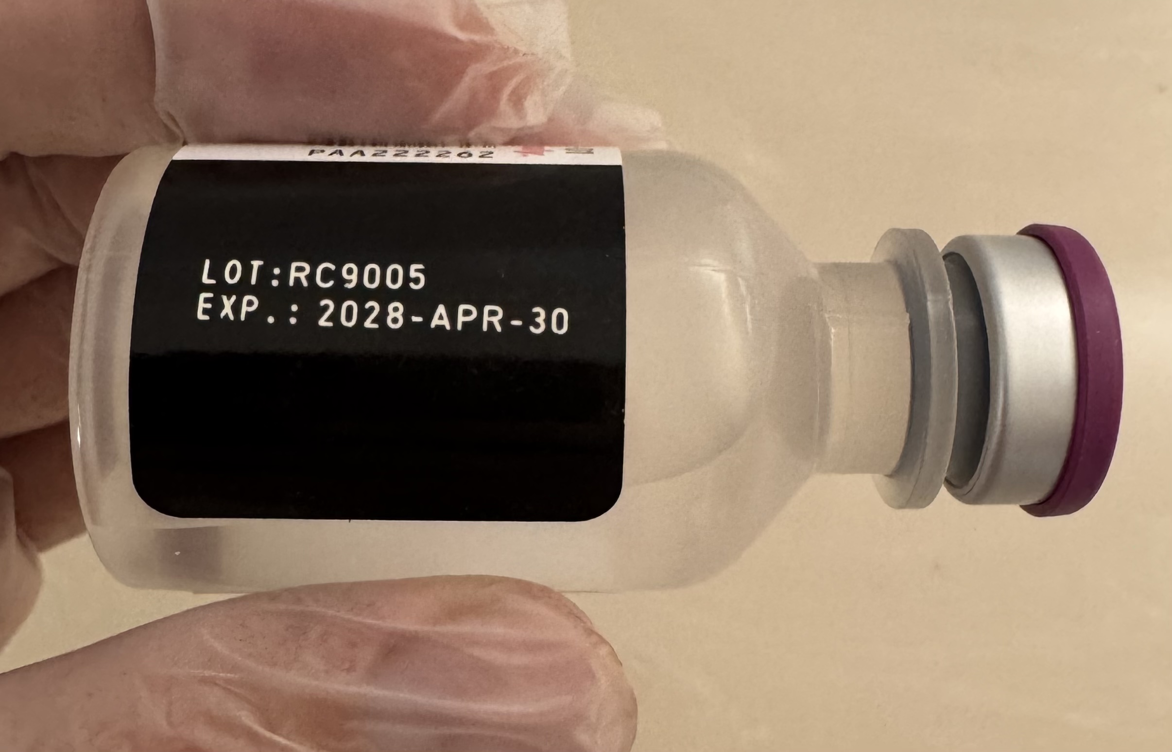 Side of the 30 mL multi-dose bacteriostatic water vial with its printed batch details