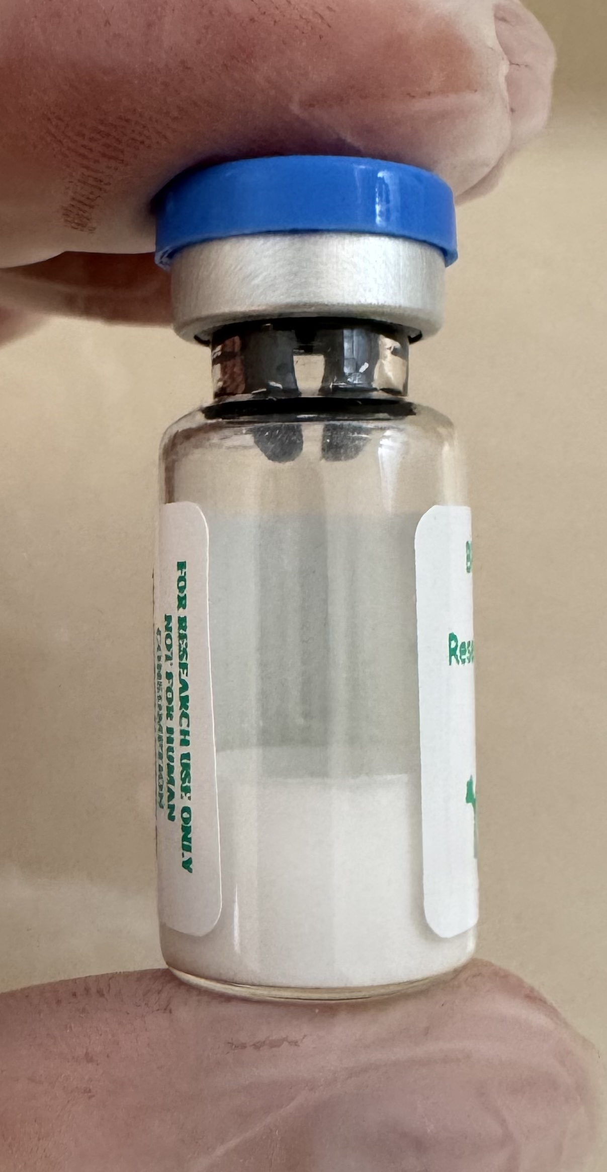 Lyophilized BPC-157 pentadecapeptide 5mg powder cake inside the sealed vial