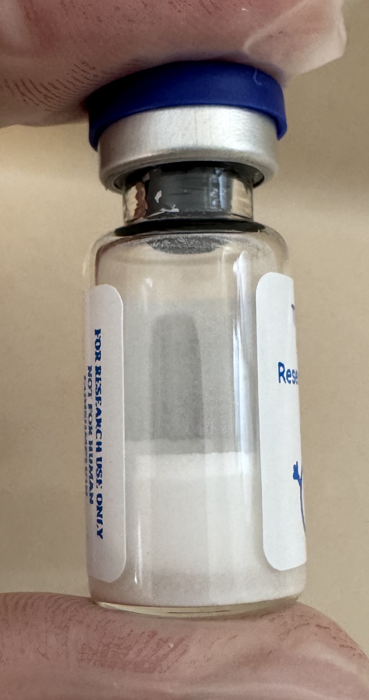 Lyophilized TB-500 thymosin beta-4 fragment 5mg powder cake inside the sealed vial